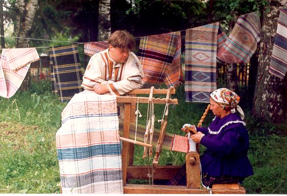Weaving of  long floor carpets. Veps festival 